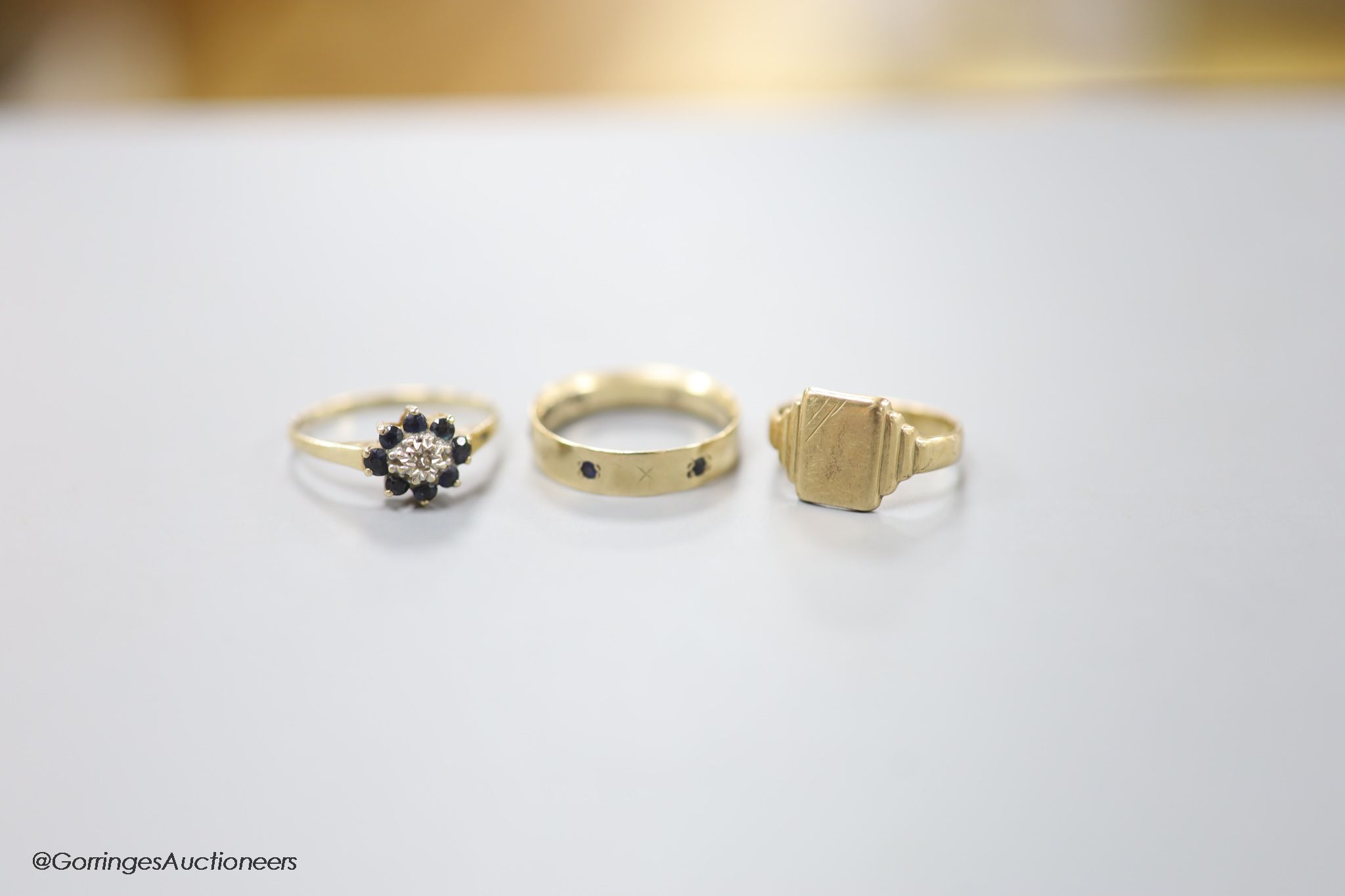 Three assorted modern 9ct gold rings including signet and gem set